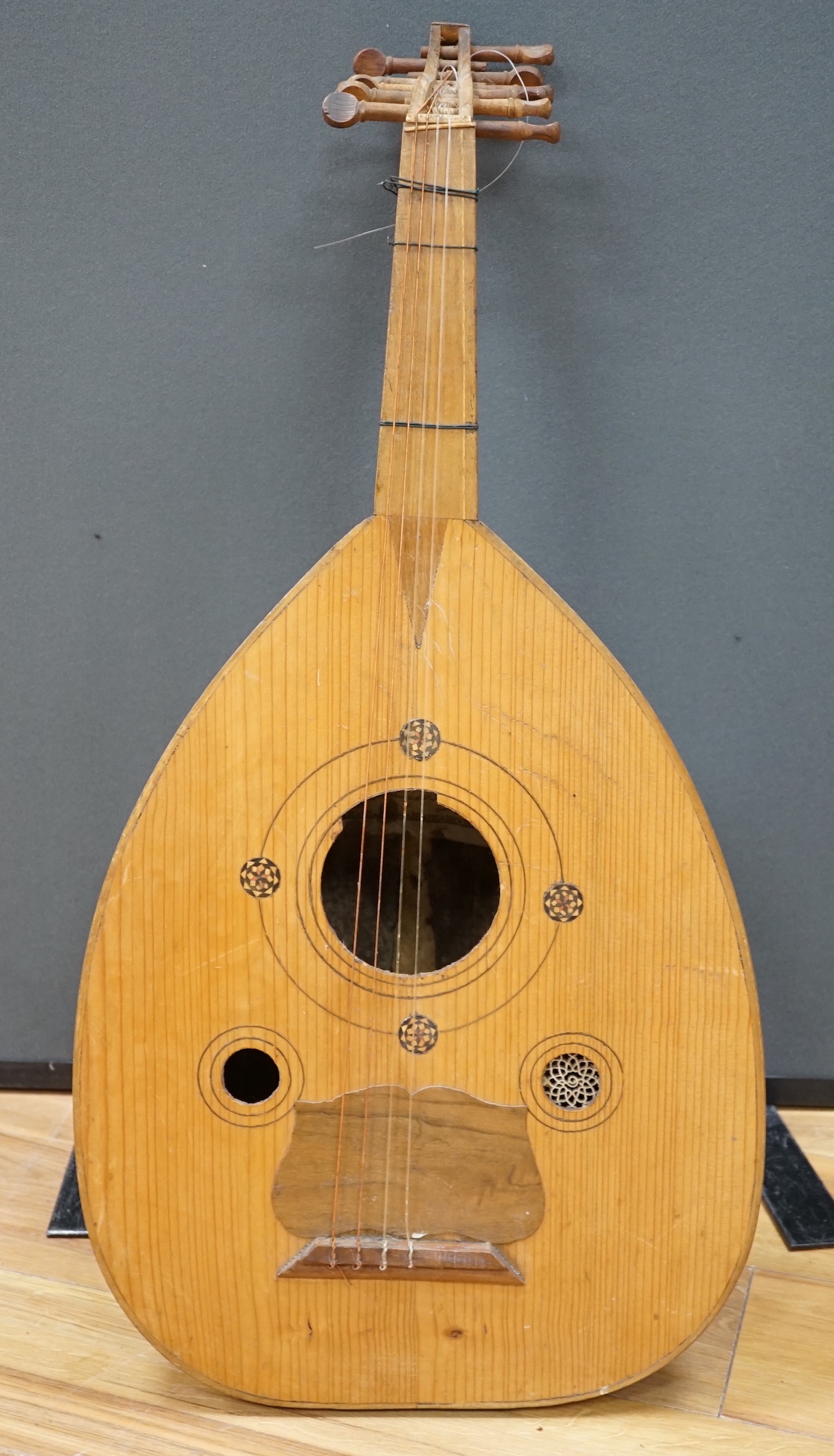 A Middle Eastern eleven string lute, overall length 82cm